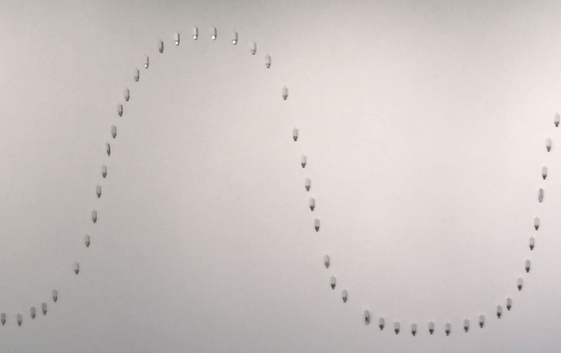 sine wave shape of USB drives on the wall